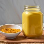 Turmeric latte, Cooking Golden Milk. Hot healthy drink.